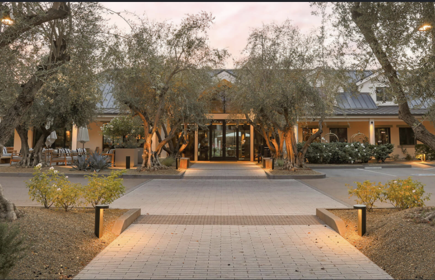 The tree-lined entrance to the Estate at Yountville at sunset